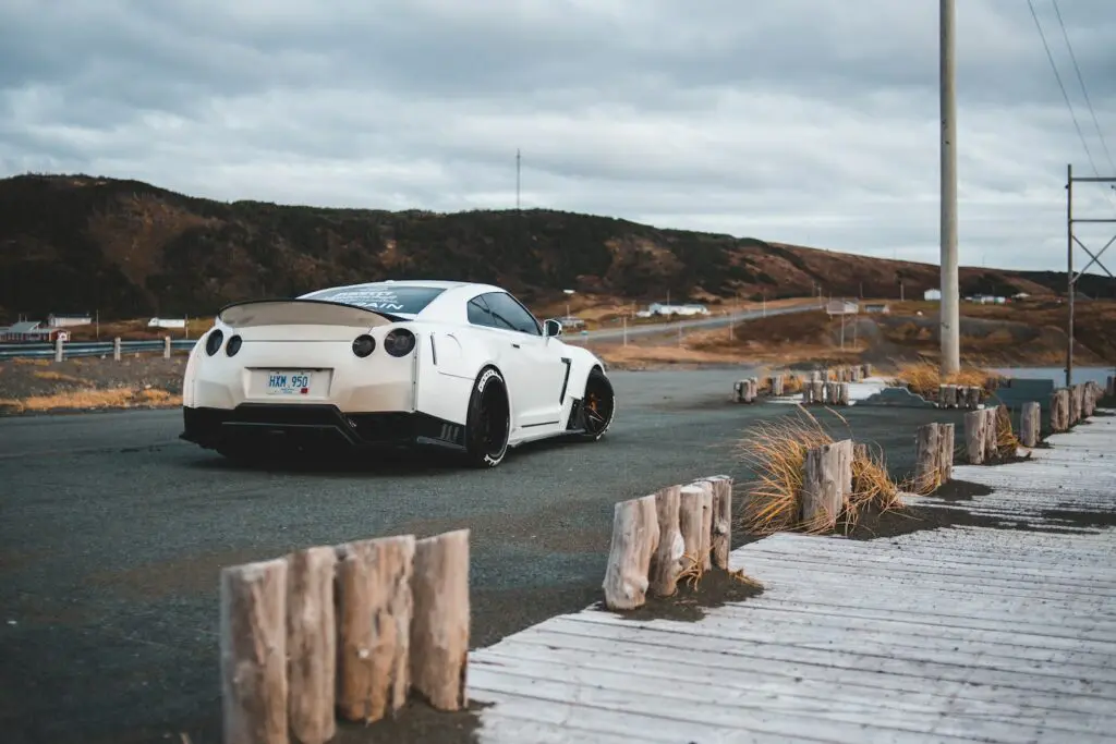 white sports coupe on road